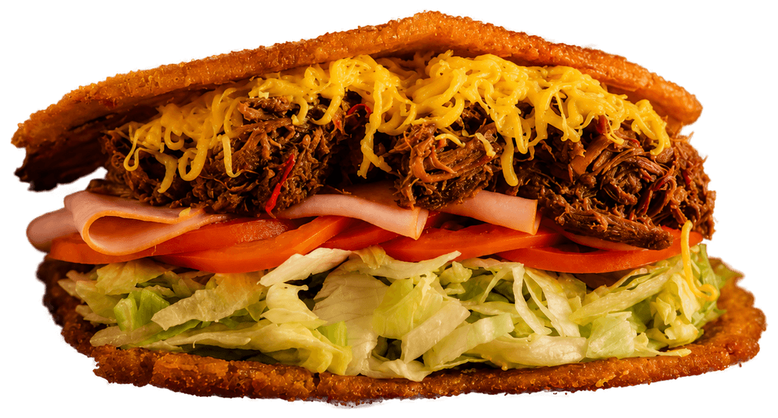 Venezuelan patacón with shredded beef, ham, cheddar, lettuce and tomato
